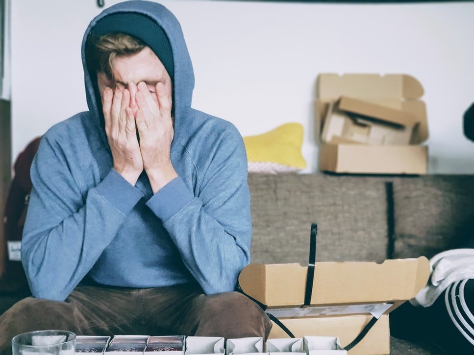 A man stressing out - manage the stress of moving house better after reading our guide