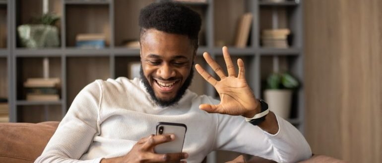 Man waving hello to the phone