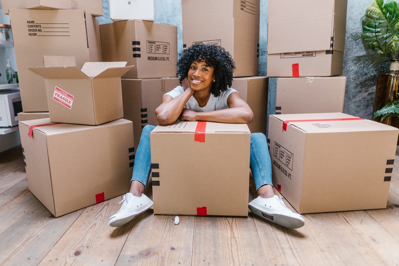 Smiling woman surrounded by boxes