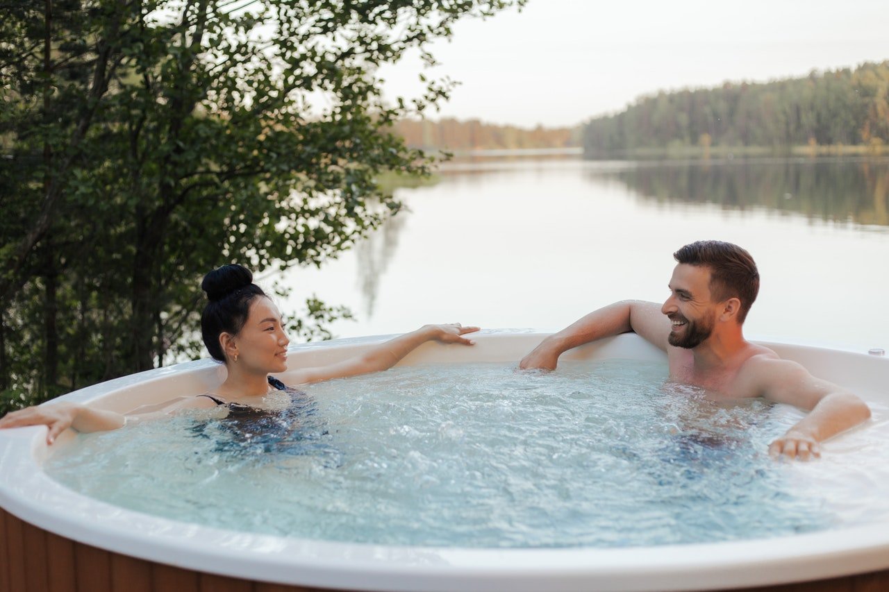 Couple looking at each other while relaxin in a hot tub