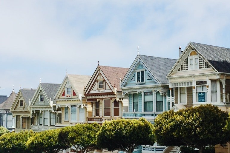 Row of colorful two-story houses.