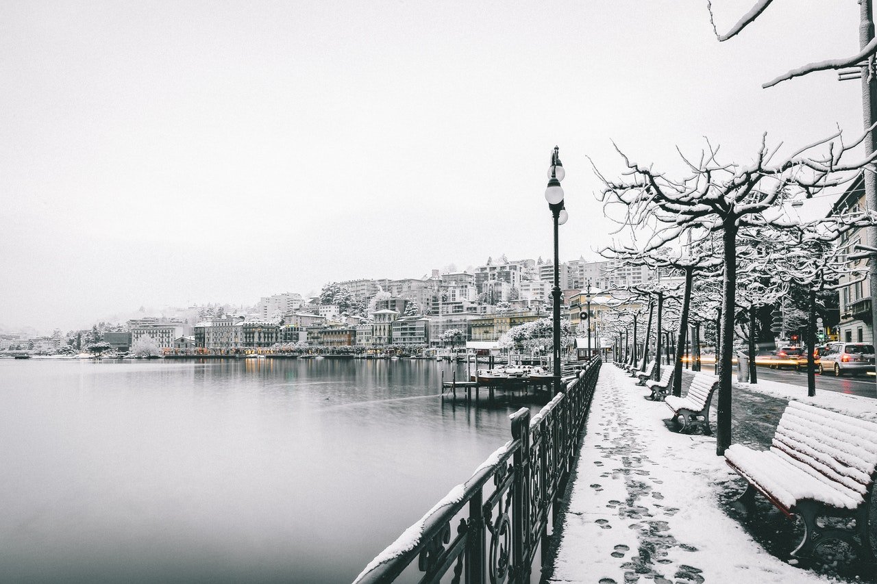 a city on the shoreline covered in snow