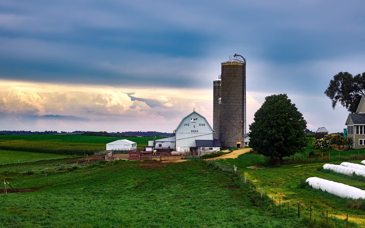 Scenic View of Landscape Against Cloudy Background