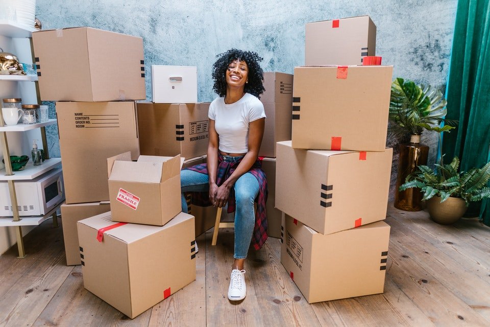 A girl surrounded with moving boxes