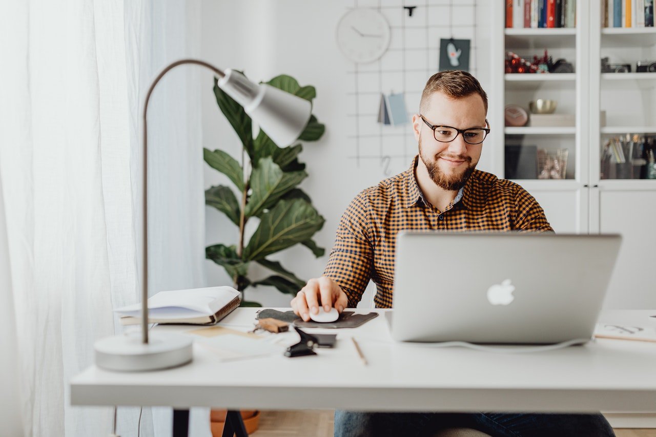 Man looking at his laptop looking for Interesting facts about Morgan Hill to learn before moving.