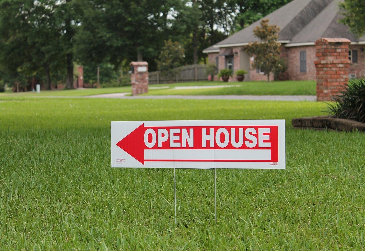 An open house sign on the lawn.