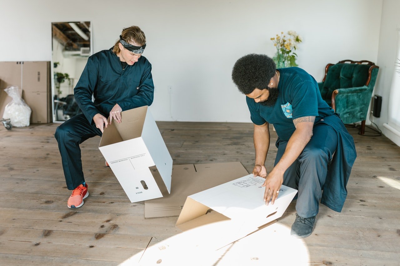 two men preparing cardboard boxes