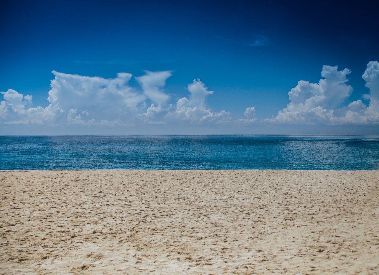 A beach with a sky overhead.