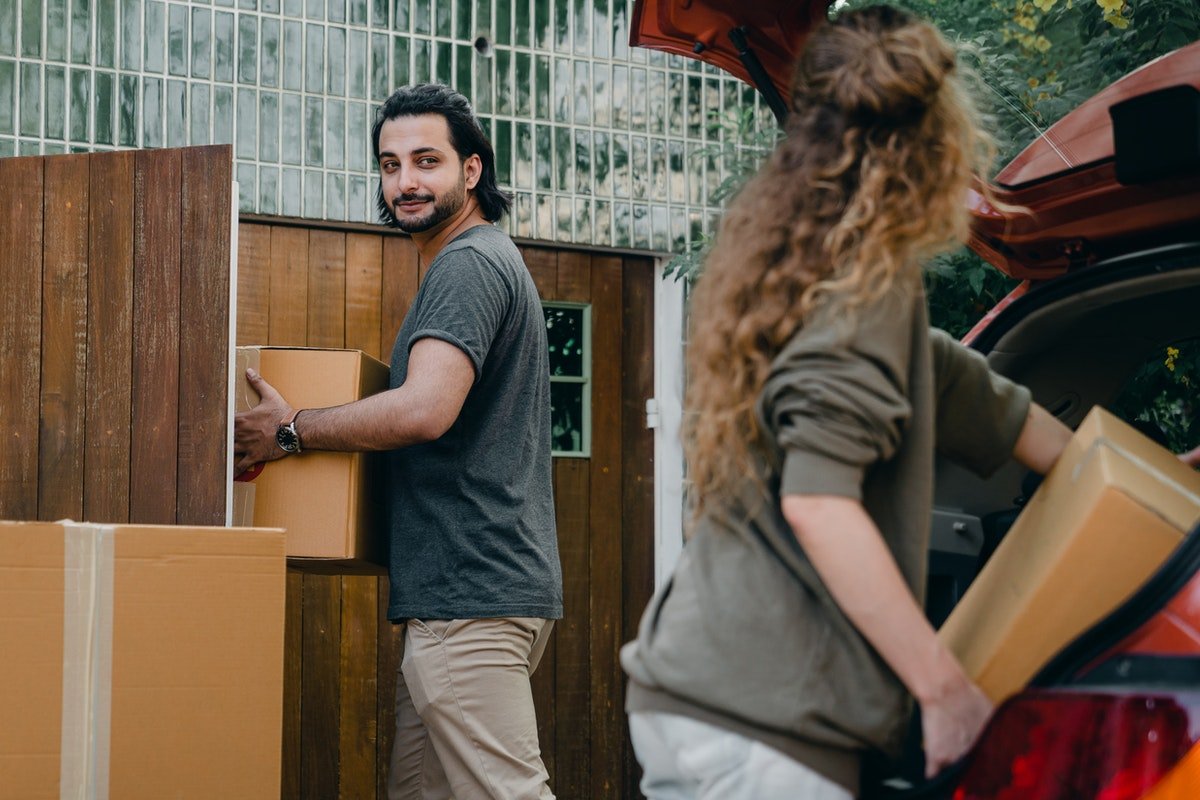 couple putting boxes into a car