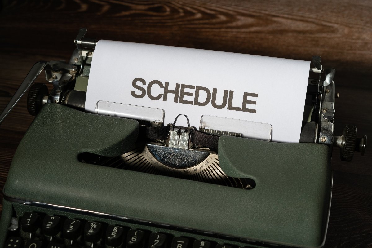 A typewriter with schedule written on the paper