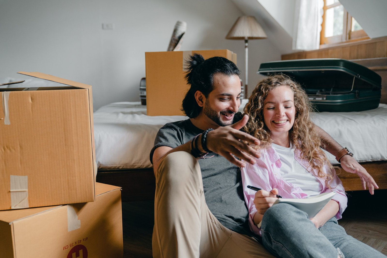 man and a women smiling in a room full of boxes