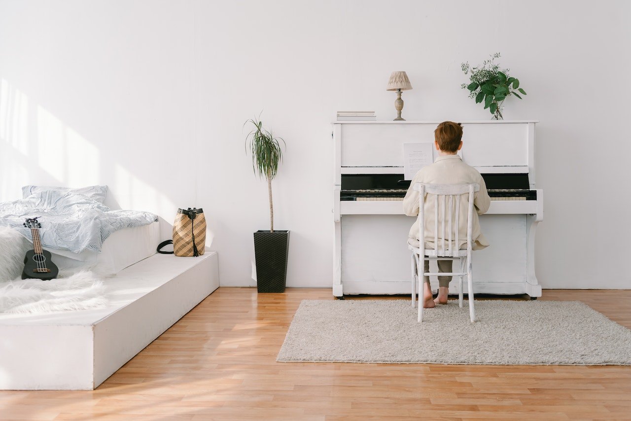 a child playing a piano in a room