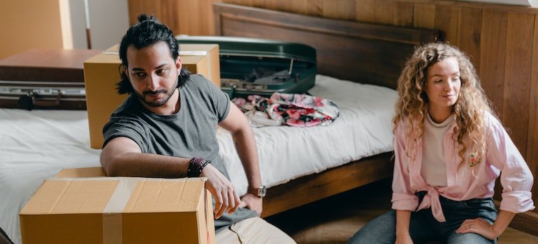 A couple packing for a move