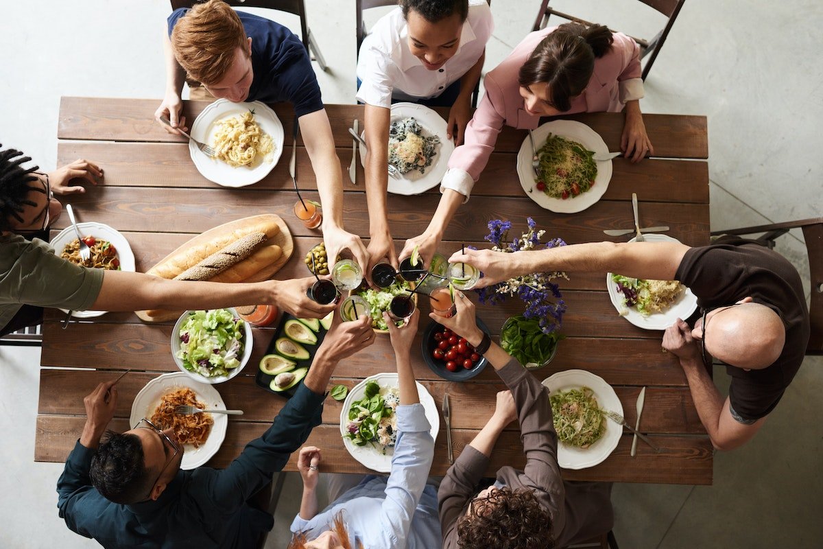 Group of people toasting and celebrating after having made their own Monterey food scene guide