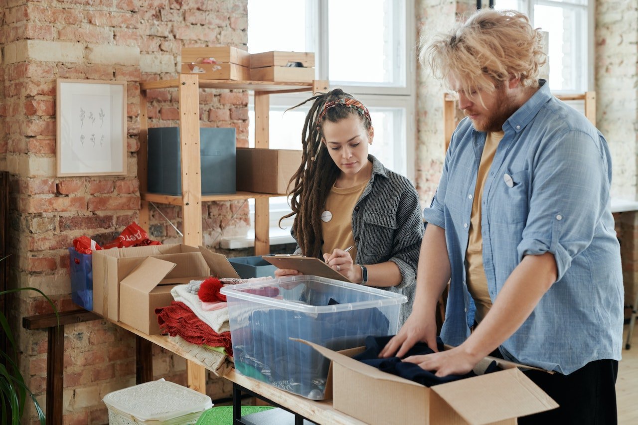 Man and woman sorting things for Sustainable packing solutions for your Gilroy move.