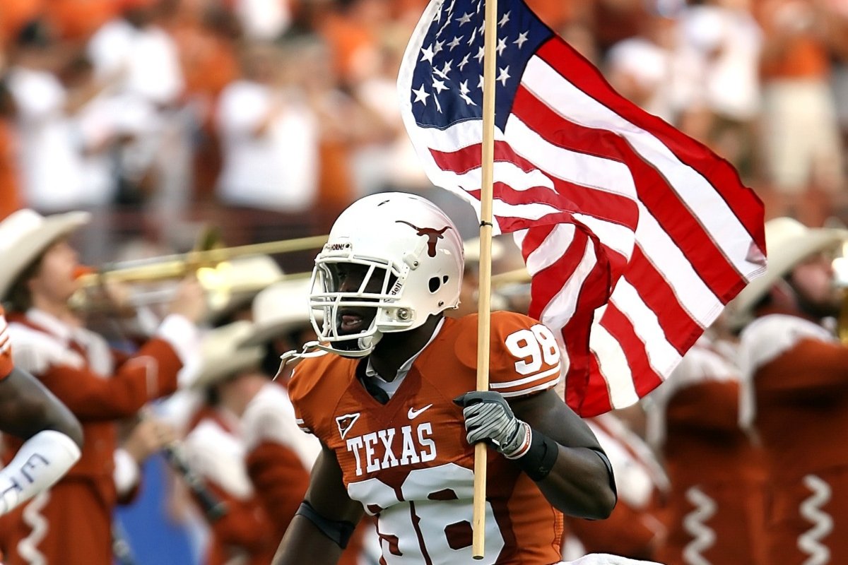football player Texas runs with the American flag in his hand