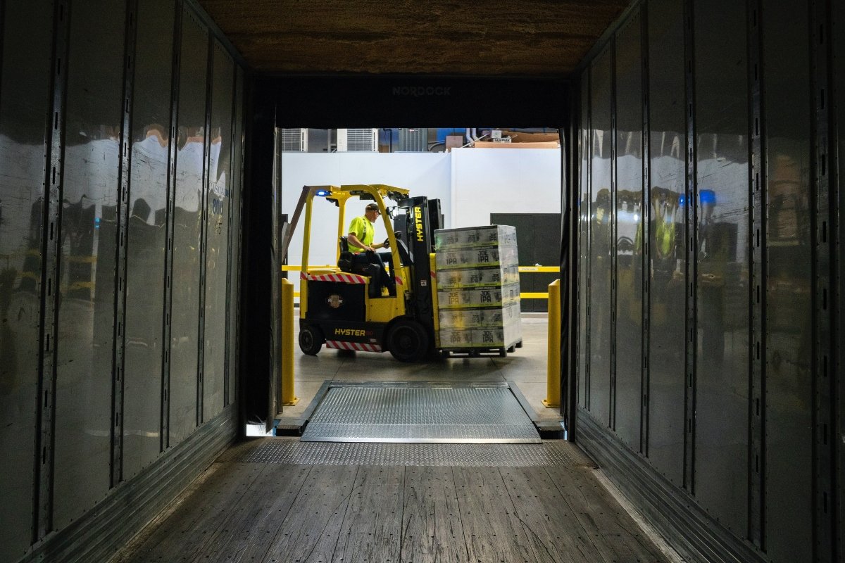 A man carry boxes using a fork lifter and the benefits of using professional storage pickup and delivery services