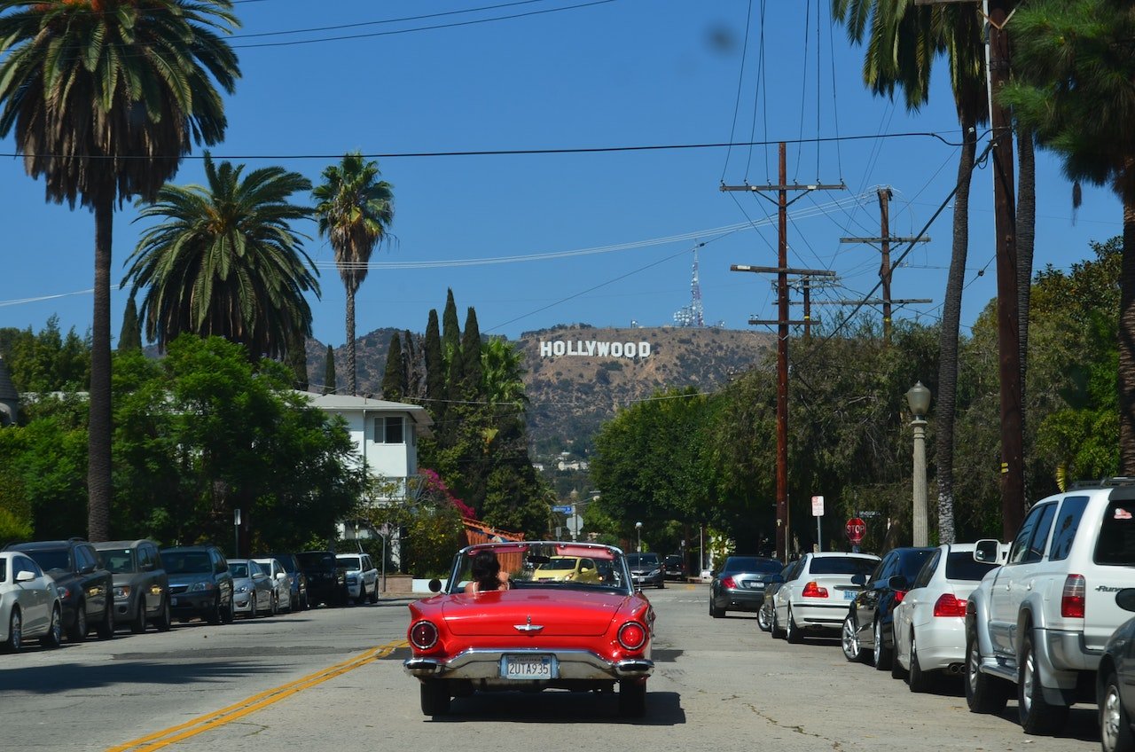 The car is driving on the streets of Hollywood.