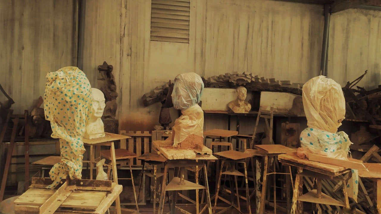 sculptures on the tables wrapped in yellow wrapping paper