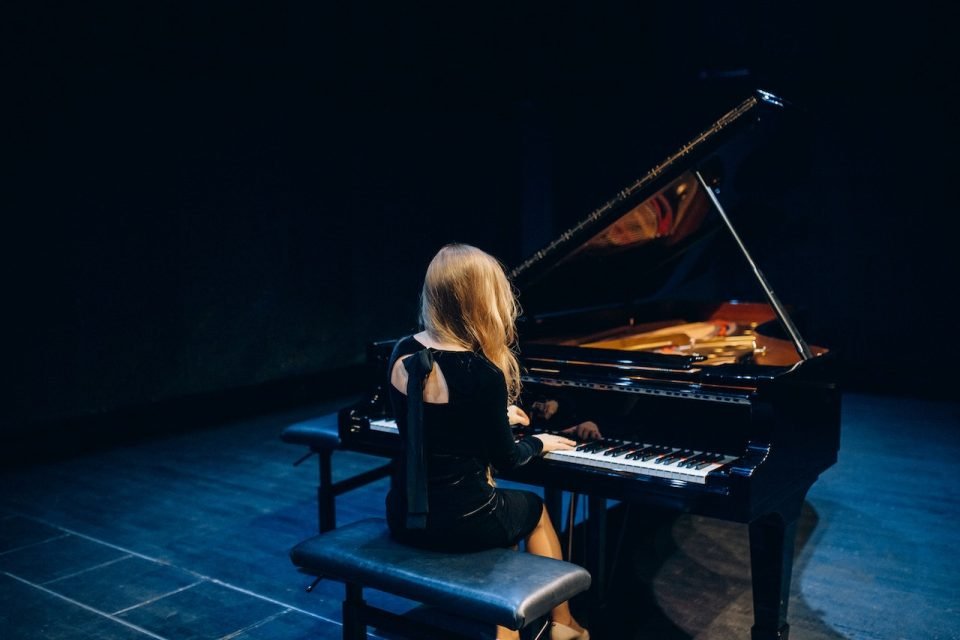 a girl playing a piano