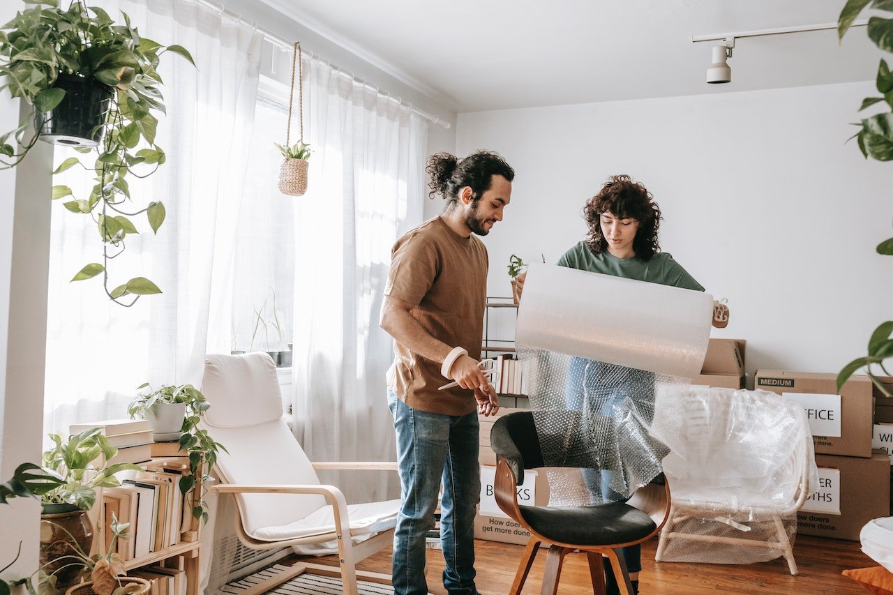 A couple securing a chair for transport