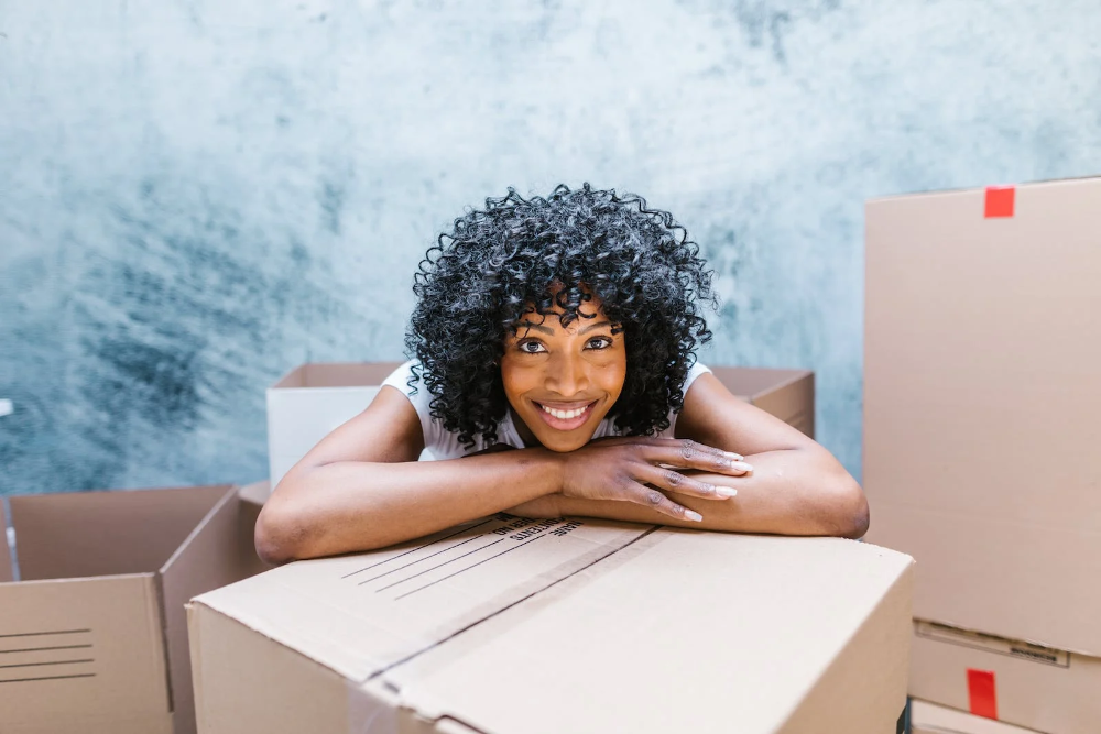 A woman smiling while packing