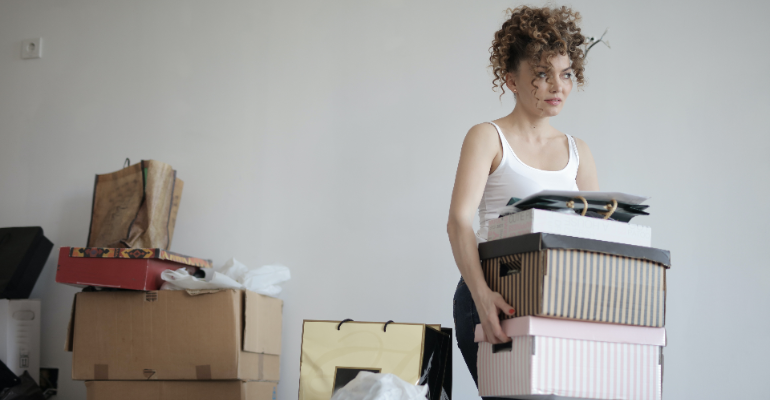A woman moving boxes.