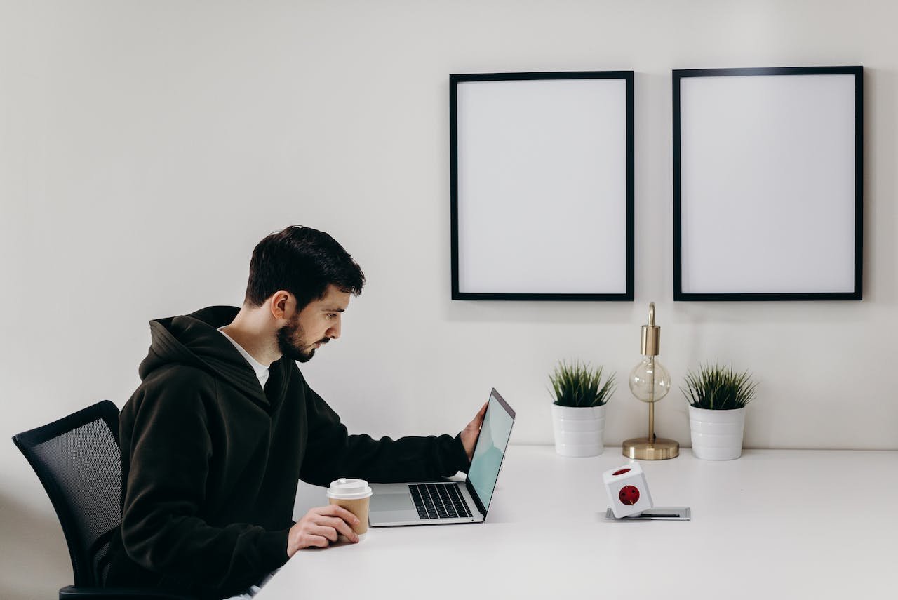 a man reading something on his laptop