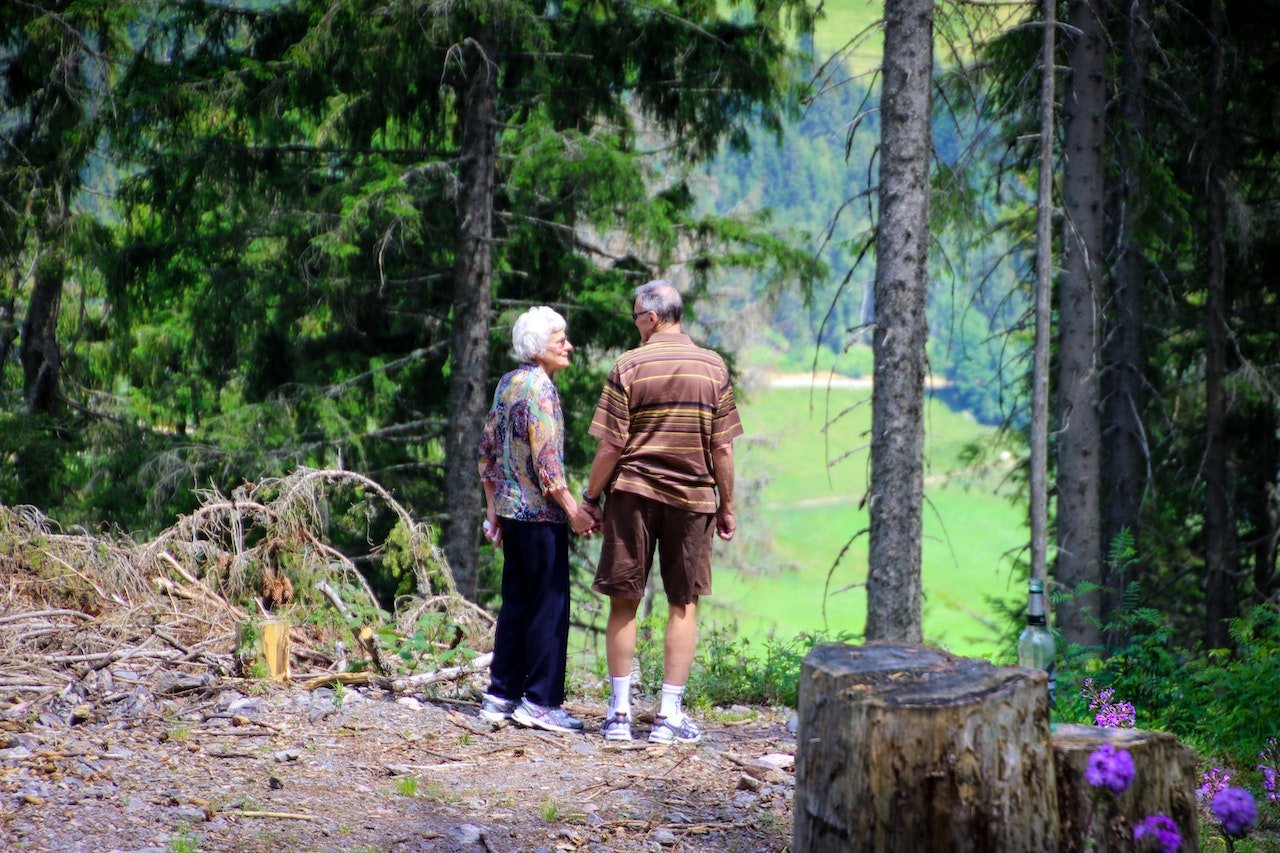 Two people standing in the forest and talking about the best places to retire in Texas.