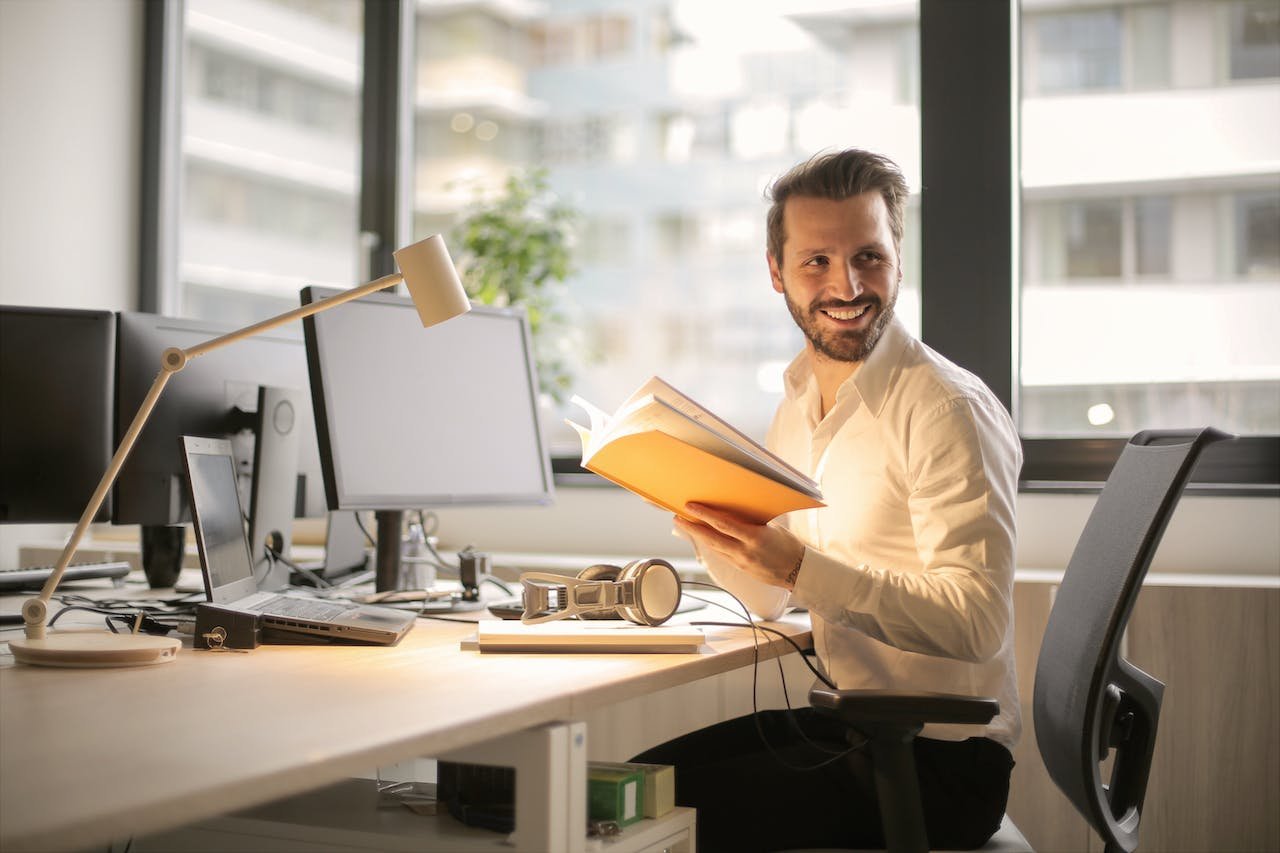 a man sitting and reading about the advantages of storage for office supplies