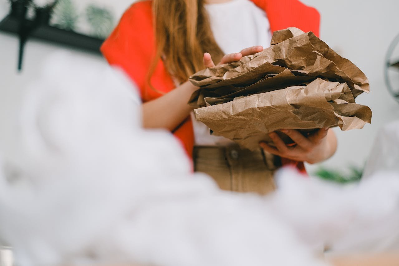 crop woman holding papers for recycling