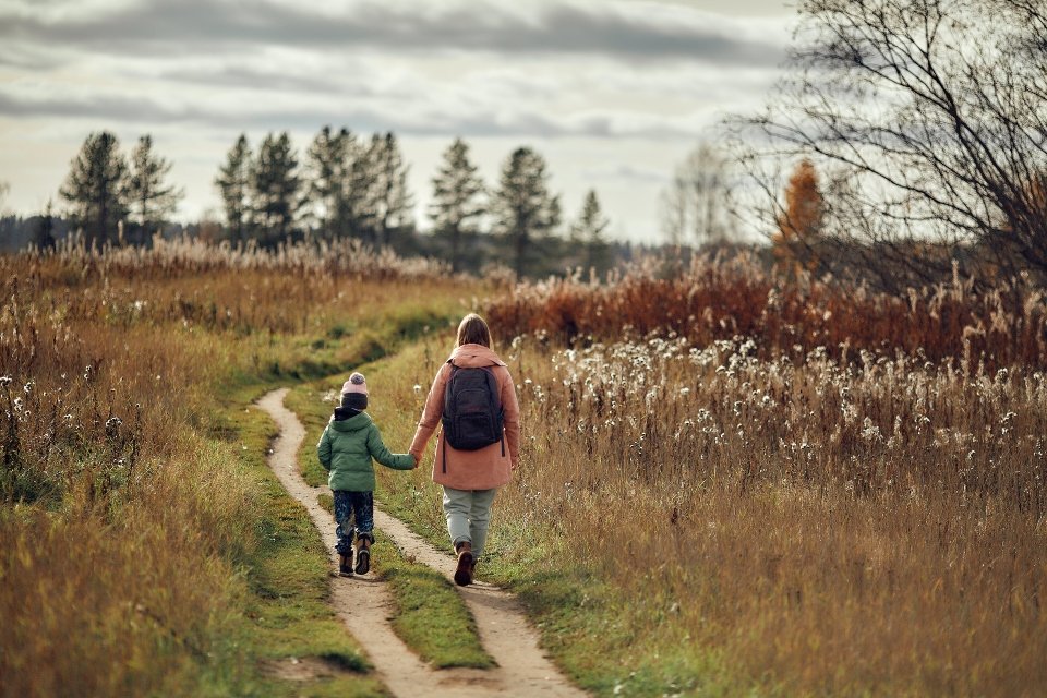 a kid and their mom walking