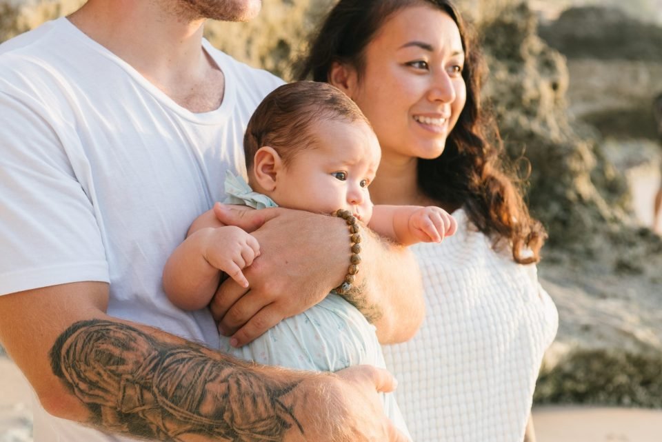 Parents with their newborn, father holding the baby