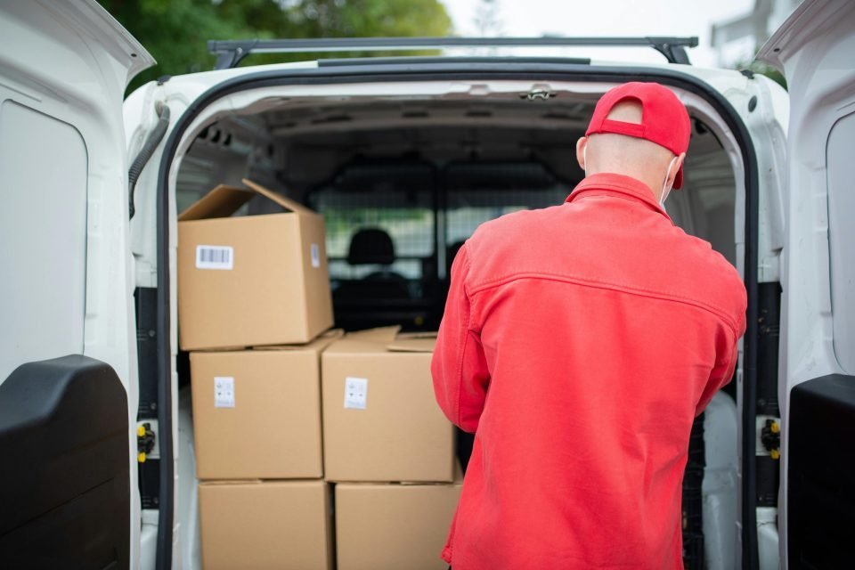 Man putting boxes inside a van