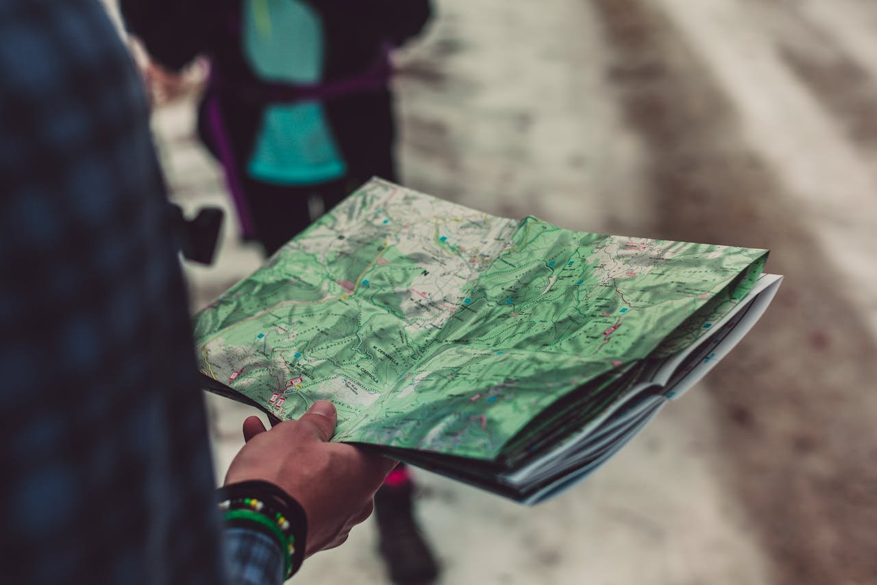 A person holding a map trying to find the best ways to explore California after moving