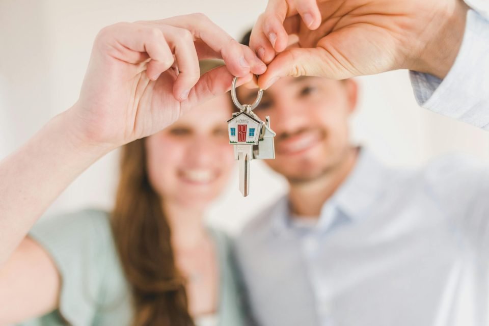 A couple holding their new house key