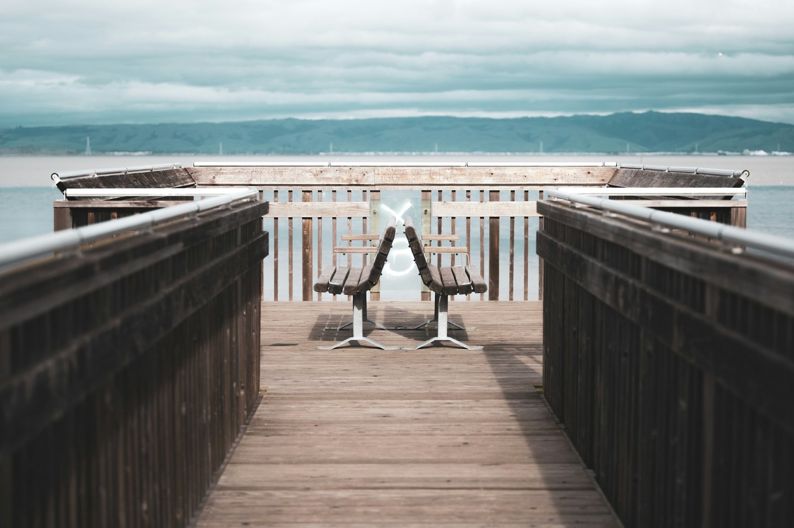 Wooden benches next to the ocean.