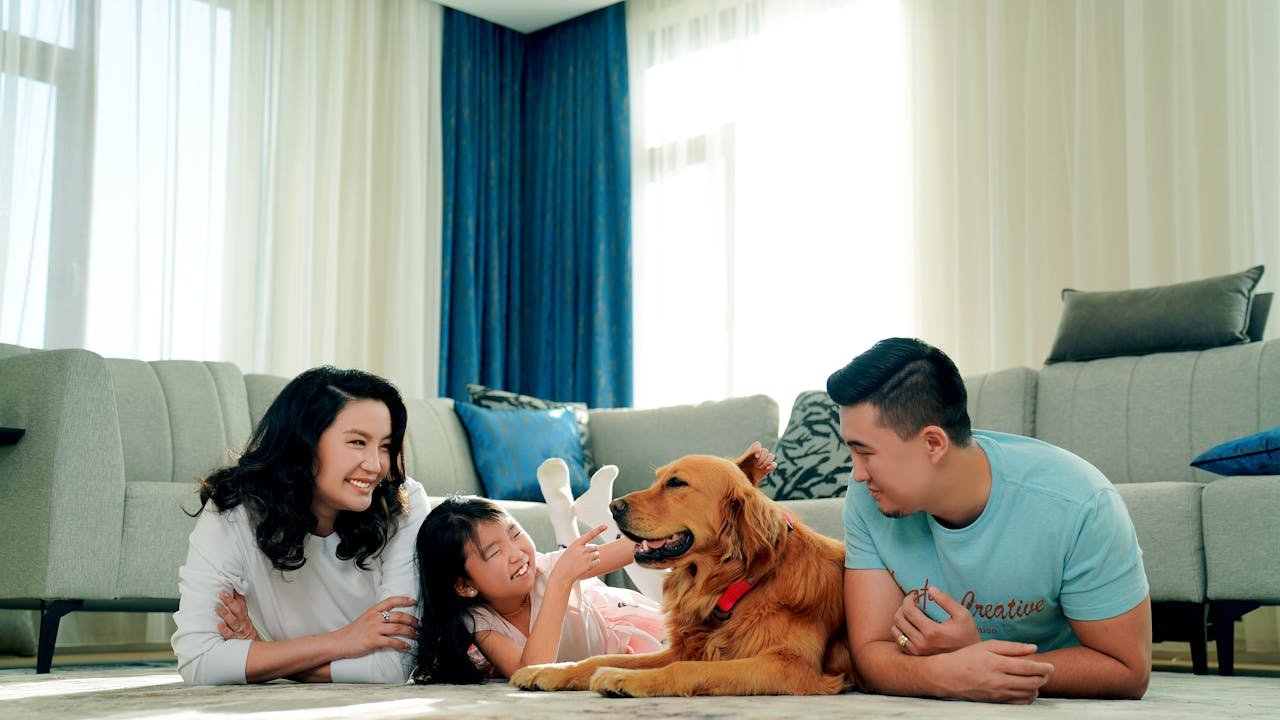family lying on the floor with their dog