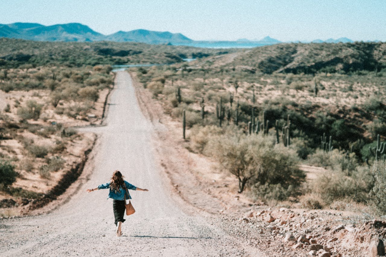 woman walking away on the dirt road