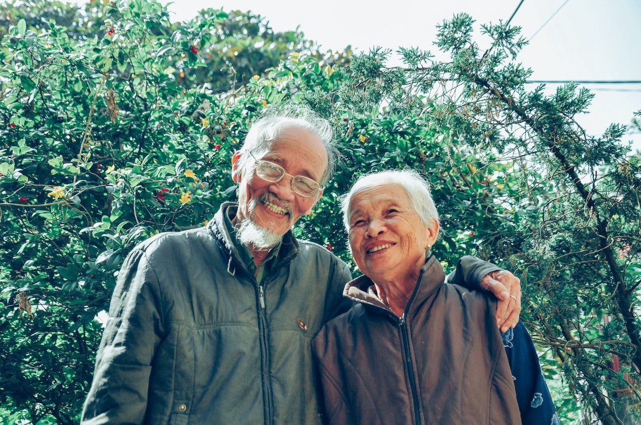 an elderly couple taking a photo