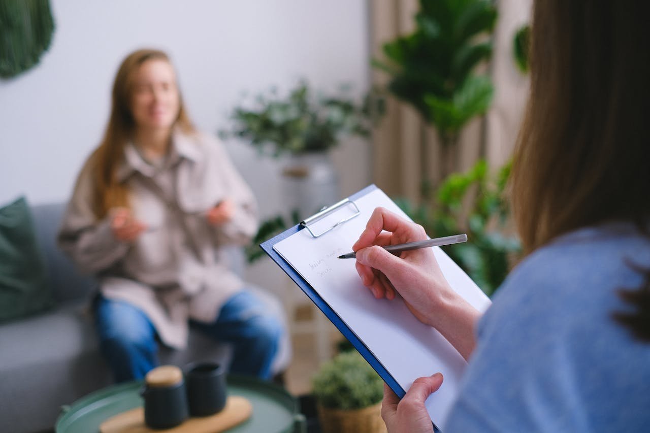 a person writing notes during an appointment