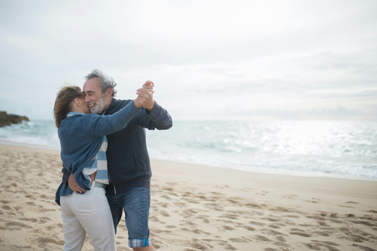 two people dancing on the beach